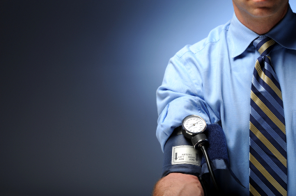 Man checking blood pressure with cuff on right arm on blue