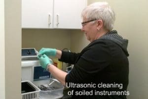 Instruments being removed from ultrasonic cleaner